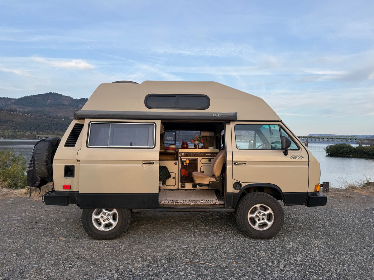 A VW Vanagon with the door open in the PNW