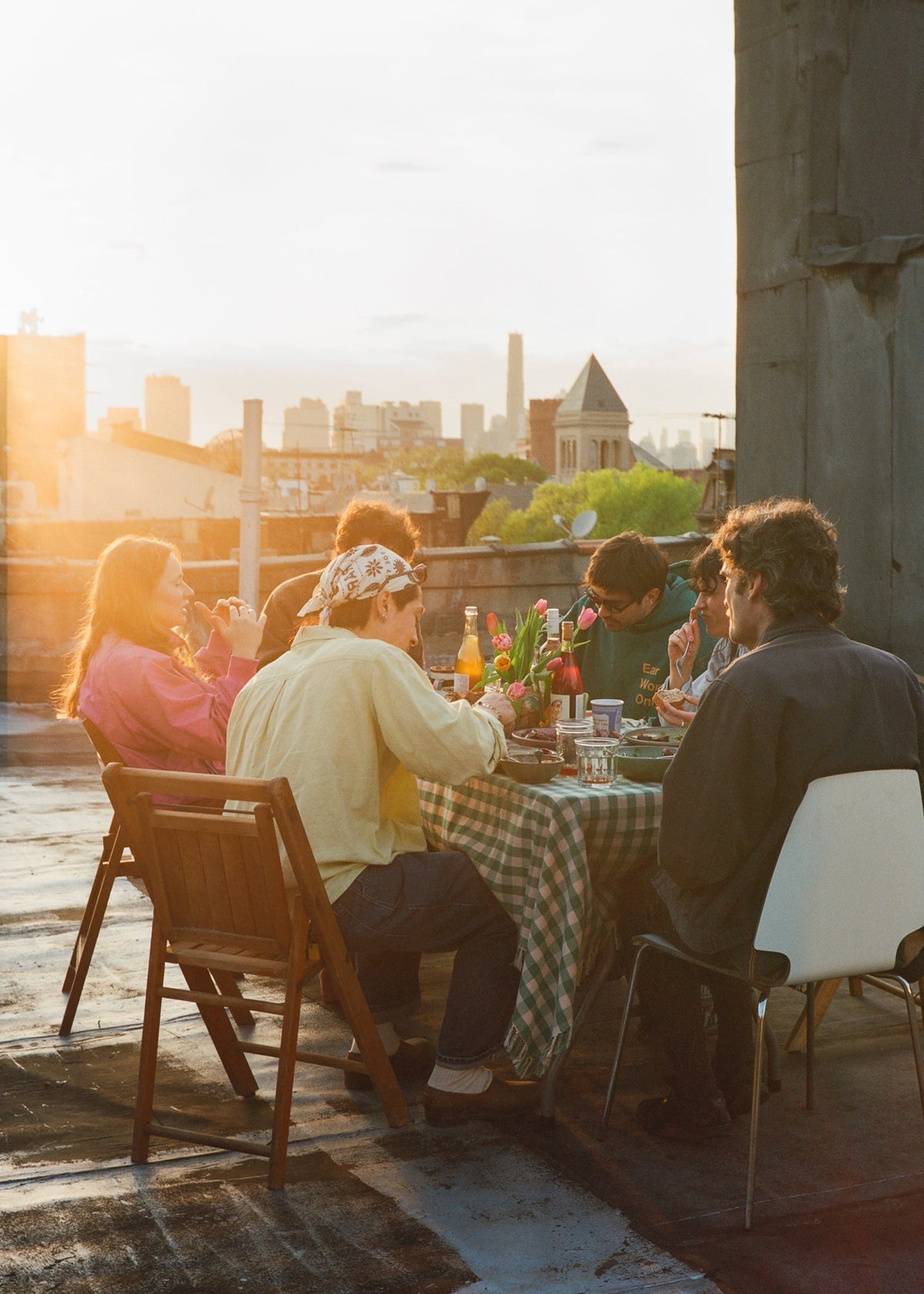 People gathered around a table at sunset.