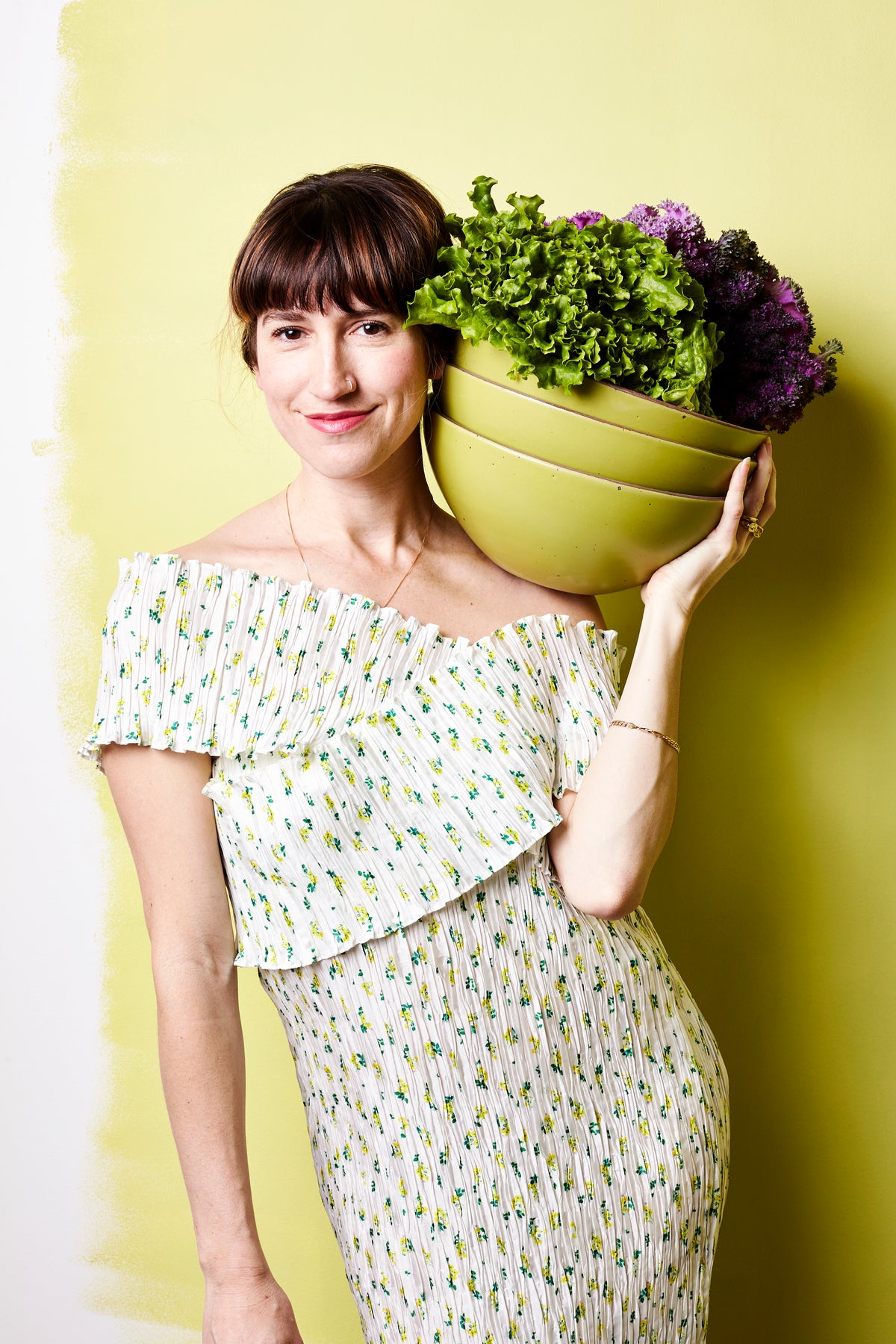 Connie holds a stack of mixing bowls in Celery