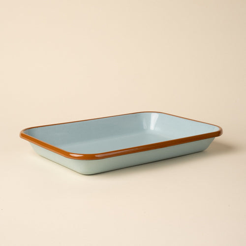 Medium rectangular baking dish in a white color with an olive green rim.