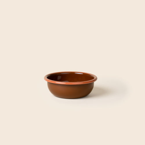 A small enamel bowl in a dark red-brown color with an orange rim.