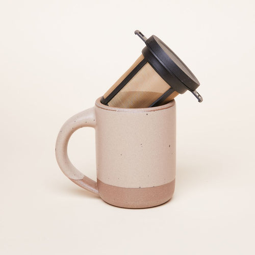 A brewing basket sitting diagonally in an East Fork Mug in Morel.