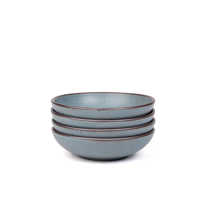 Set of four blue-grey ceramic shallow bowls on a white background