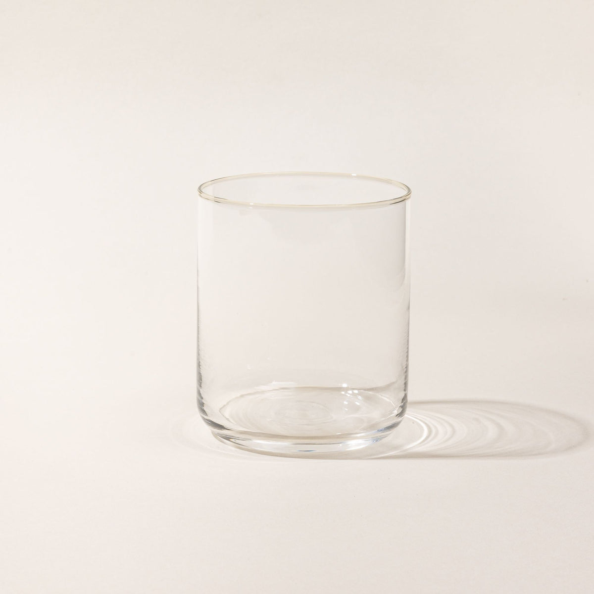 A straight walled short glass cup