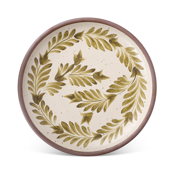A large ceramic platter in a warm, tan-toned, off-white color featuring iron speckles and an unglazed rim, with handpainted greenery in an olive green color.