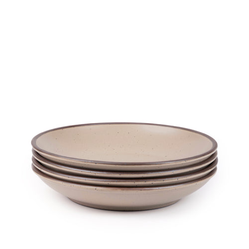 A stack of 4 large ceramic plates with a curved bowl edge in a pale warm brown color featuring iron speckles and an unglazed rim.