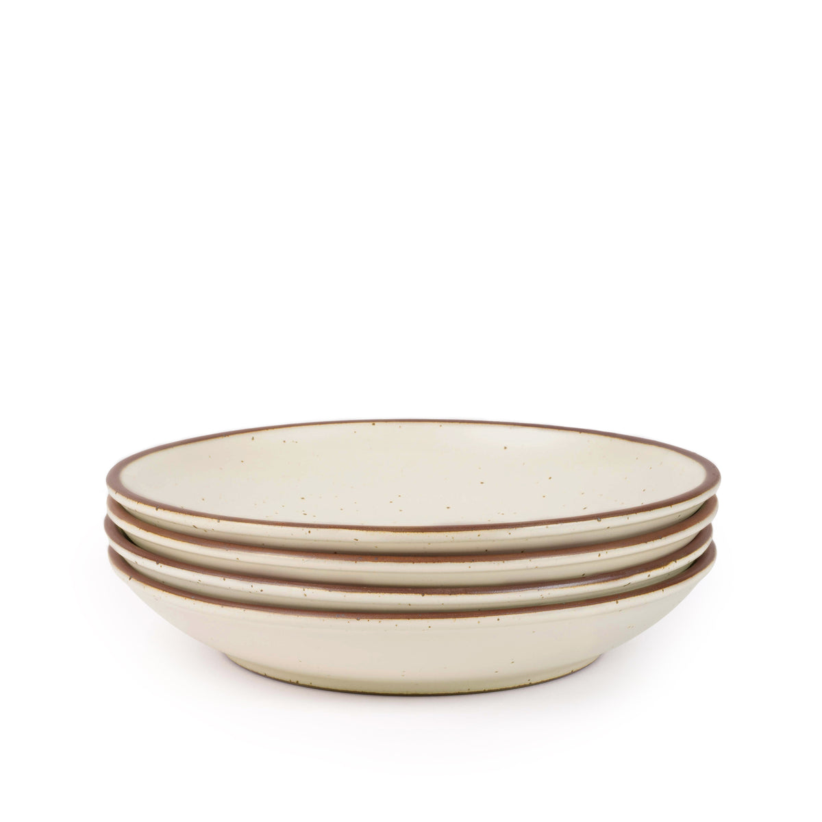 A stack of 4 large ceramic plates with a curved bowl edge in a warm off-white color featuring iron speckles and an unglazed rim.