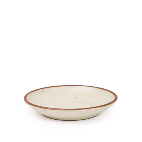 A medium ceramic plate with a curved bowl edge in a warm, tan-toned, off-white color featuring iron speckles and an unglazed rim.