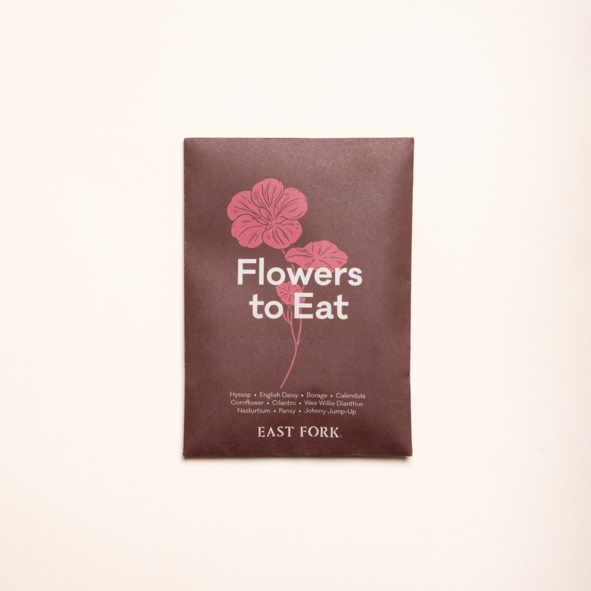 Flowers to Eat seed packet with pink floral illustration on a light background.