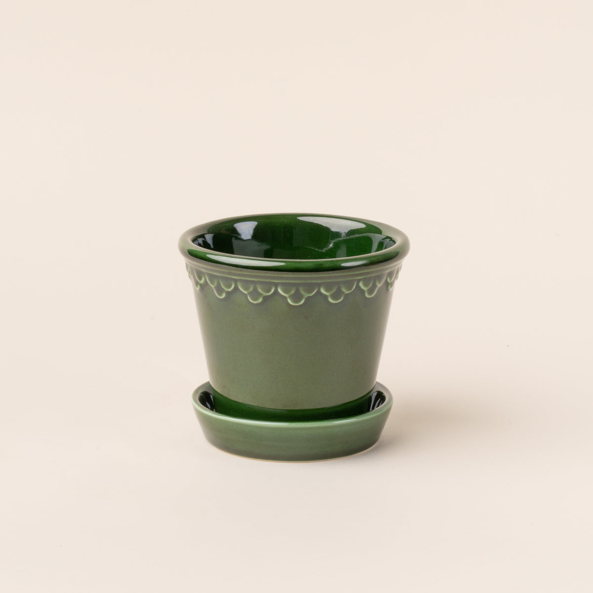 Small glossy green ceramic pot.