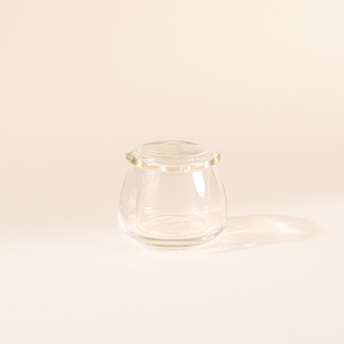 Clear glass butter keeper on white background
