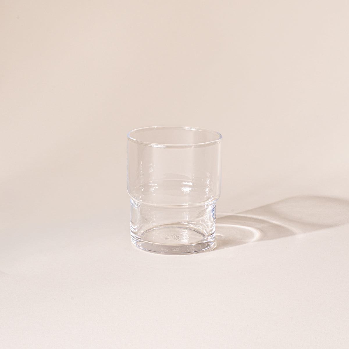 Clear cylindrical glass with a wider top half with a narrower bottom half