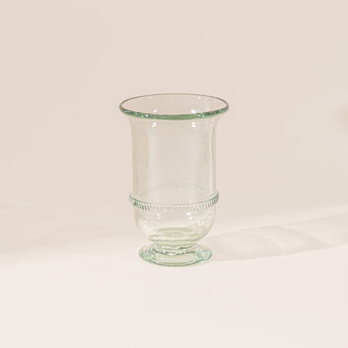 Clear glass vase with a flared rim, pedestal base, and decorative band detail at the center, set against a neutral background.
