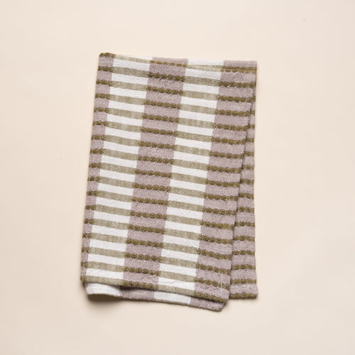 Folded woven kitchen towel with olive green and beige striped pattern on a light background.