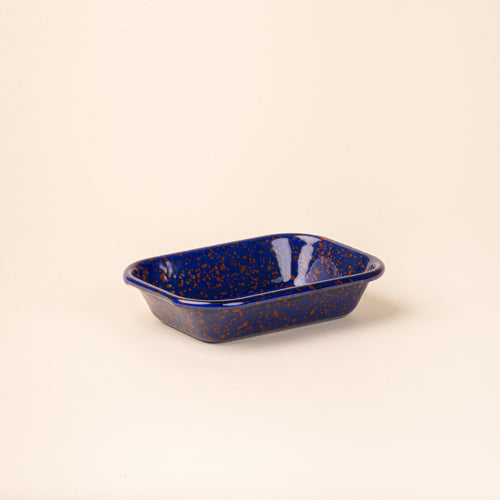 Small rectangular baking dish in a midnight blue color with red splatter pattern.