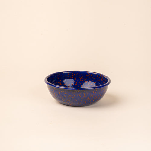 A medium enamel bowl in midnight blue color with red splatter pattern.