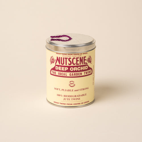Metal tin of Nutscene Deep Orchid garden twine with purple jute string.