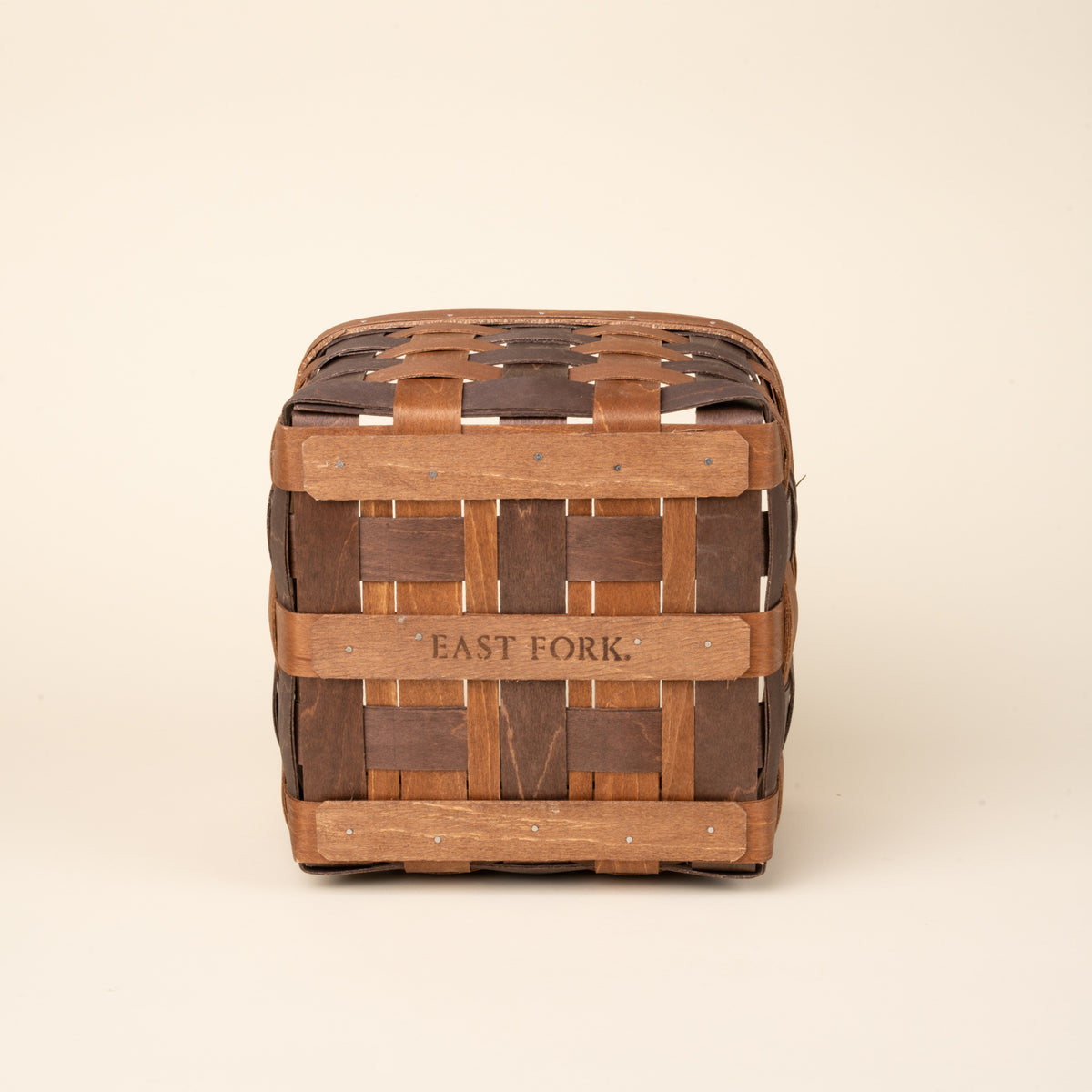 Bottom of a medium rectangular woven wood basket in two-tone brown with an open top and reinforced rim, shown against a neutral background.