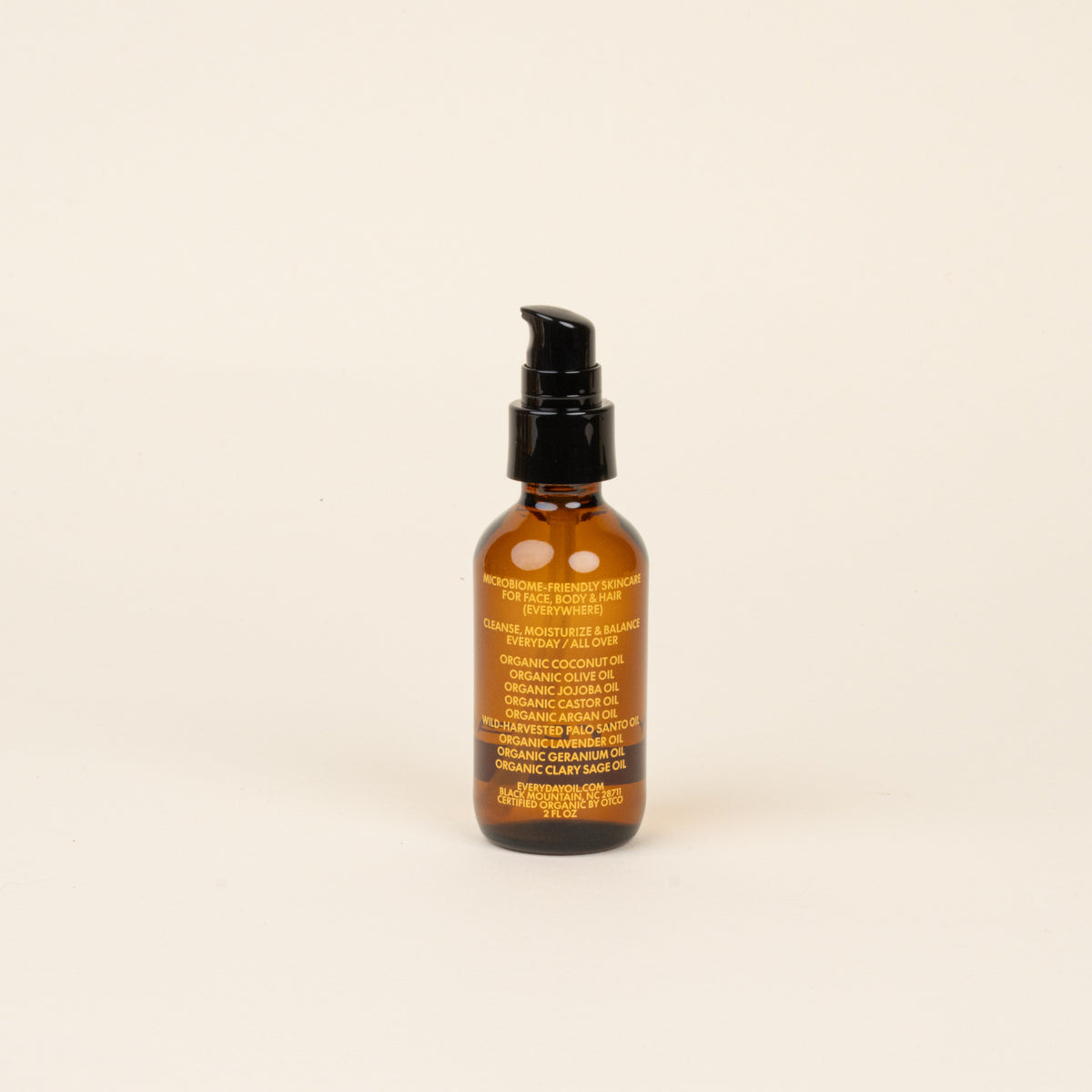 Brown bottle with black cap on a beige background