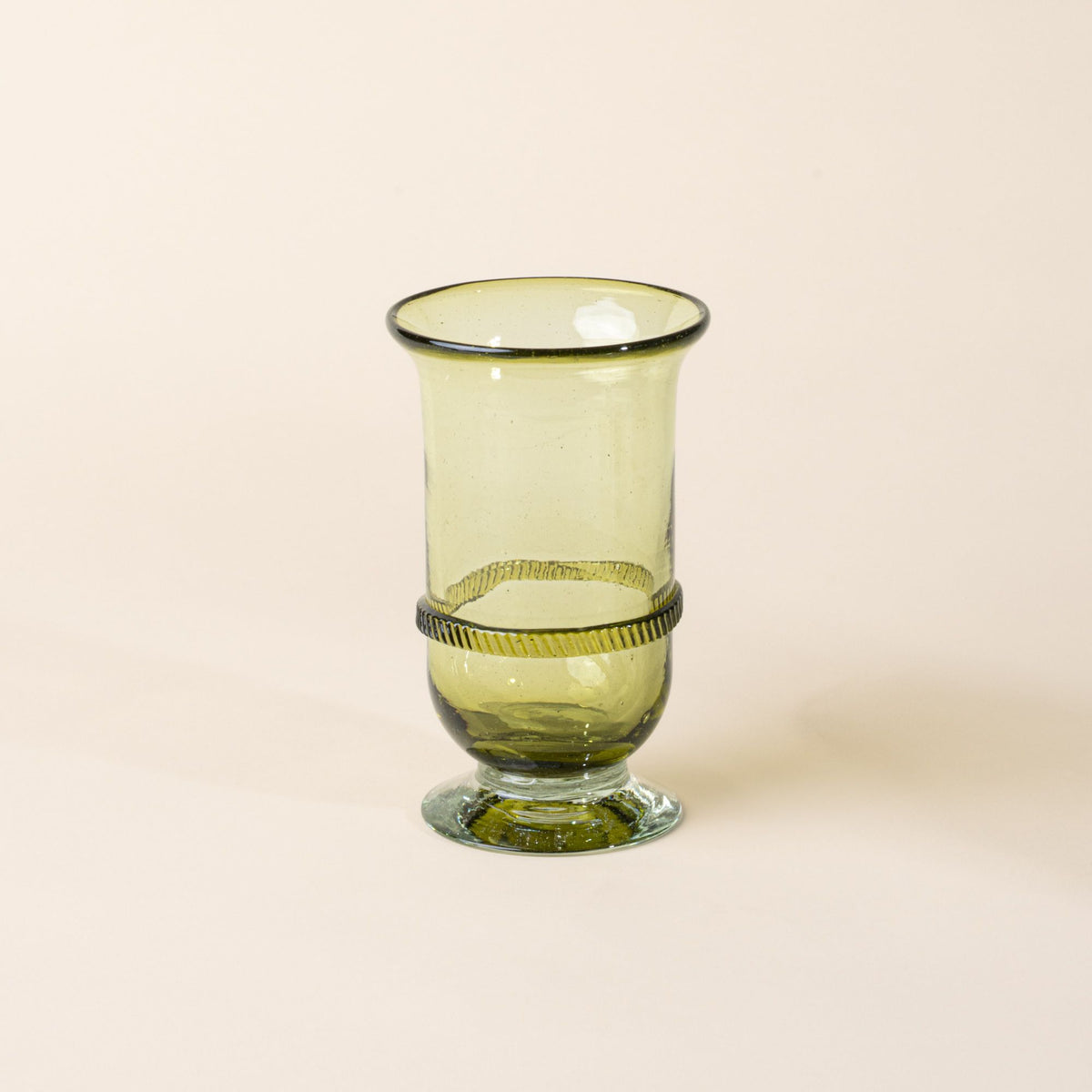Light green glass vase with a flared rim, pedestal base, and decorative band detail at the center, set against a neutral background.