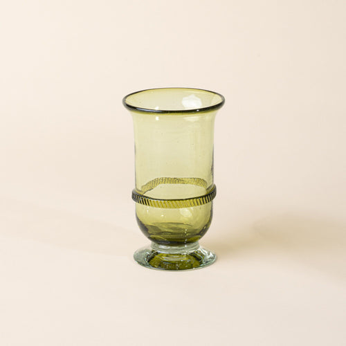 Light green glass vase with a flared rim, pedestal base, and decorative band detail at the center, set against a neutral background.