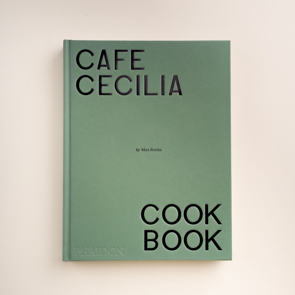 Front cover of Cafe Cecilia Cookbook by Max Rocha, published by Phaidon, in a minimalist green design with bold black lettering.