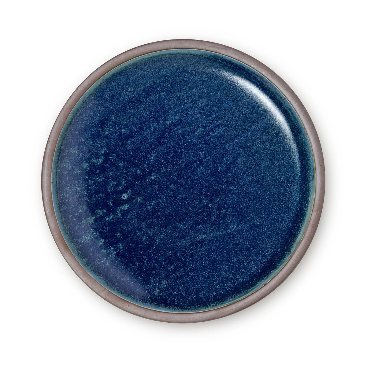 A large ceramic platter in a reflective dappled deep blue color and an unglazed rim.
