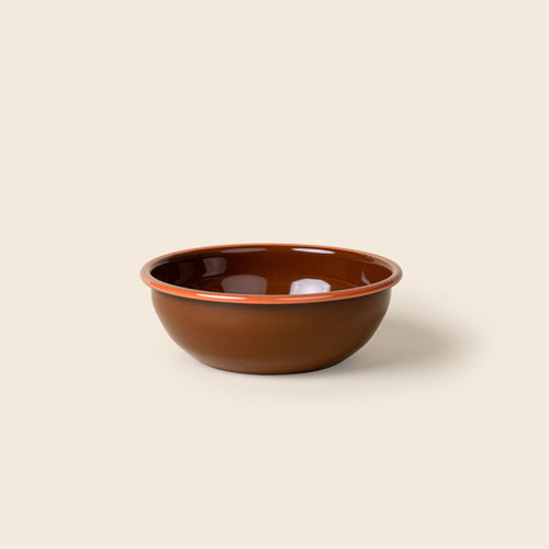 A medium enamel bowl in a dark red-brown with an orange rim.