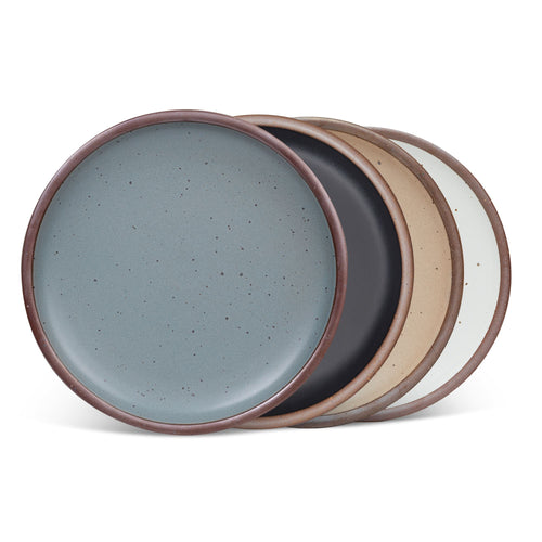 4 dinner sized ceramic plates in a blue-grey, graphite black, warm pale brown and cool white colors featuring iron speckles and an unglazed rim
