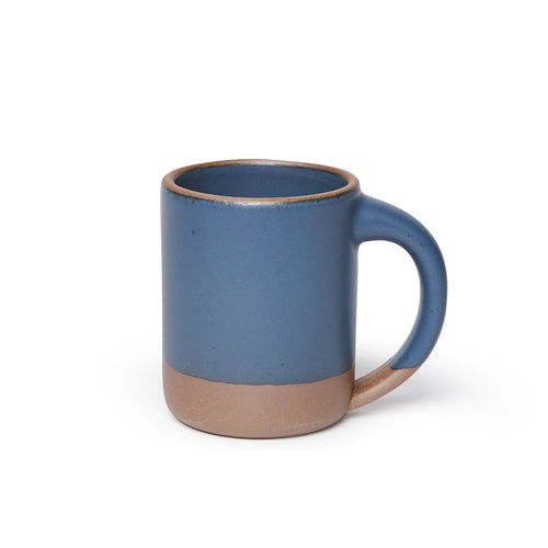 A big sized ceramic mug with handle in a toned-down navy glaze featuring iron speckles and unglazed rim and bottom base.