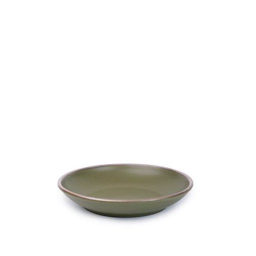 A small ceramic plate with a curved bowl edge in an olive green color featuring iron speckles and an unglazed rim.