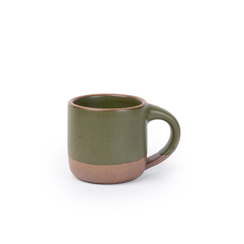 A small sized ceramic mug with handle in an olive green glaze featuring iron speckles and unglazed rim and bottom base.