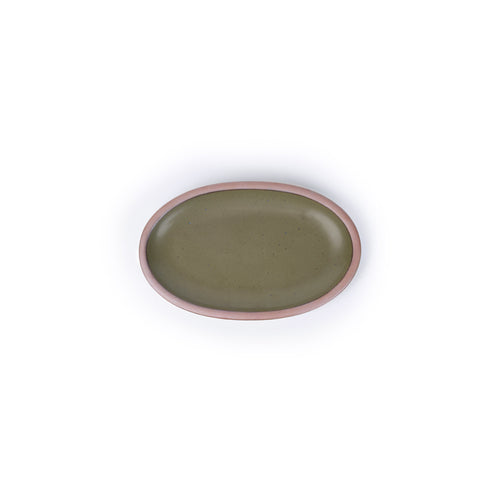 A small oval ceramic platter in an olive green color featuring iron speckles and an unglazed rim
