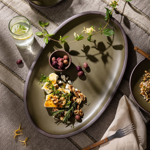 Olive-toned stoneware oval platter, styled with artisan cheese, olives, and walnuts for effortless entertaining.