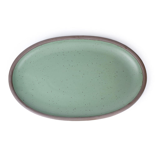 An oval ceramic platter for serving at the table in a viridian green glaze with a matte finish.