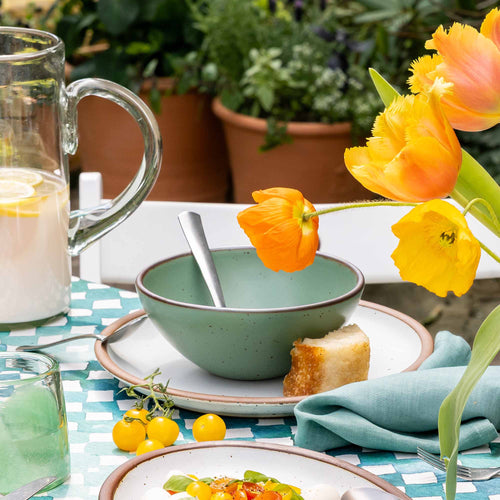 A ceramic bowl with higher sides for soups or stews in a viridian green glaze with a matte finish.