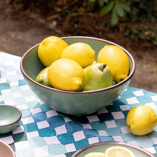 A ceramic bowl with a wide opening for serving snacks in a viridian green glaze with a matte finish.