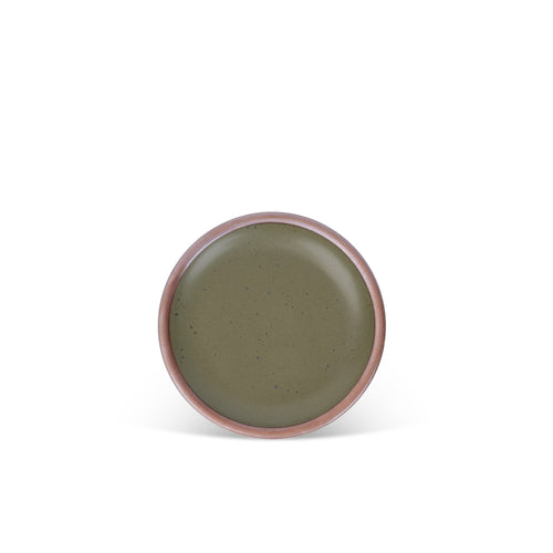 A dessert sized ceramic plate in an olive green color featuring iron speckles and an unglazed rim.