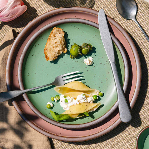 A ceramic plate fit for lunch of small meals in a viridian green glaze with a matte finish.