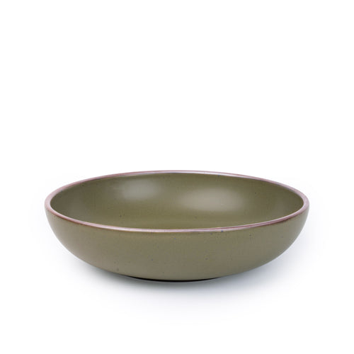 A large shallow serving ceramic bowl in an olive green color featuring iron speckles and an unglazed rim.