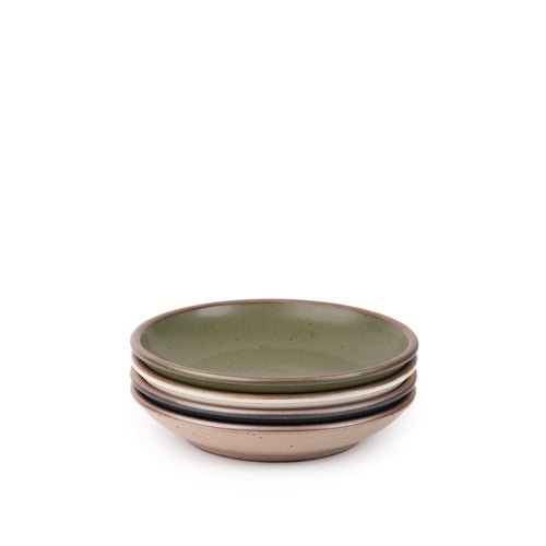 A stack of 4 small ceramic plates with a curved bowl edge in an olive green, graphite black, off-white, and warm pale brown colors featuring iron speckles and an unglazed rim.