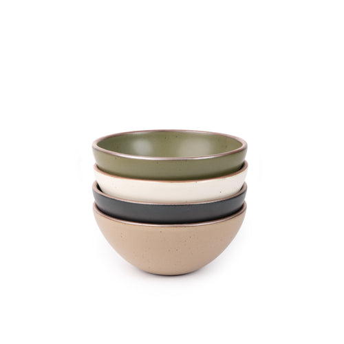 A stack of 4 medium sized rounded ceramic bowls in an olive green, graphite black, off-white, and warm pale brown colors featuring iron speckles and an unglazed rim