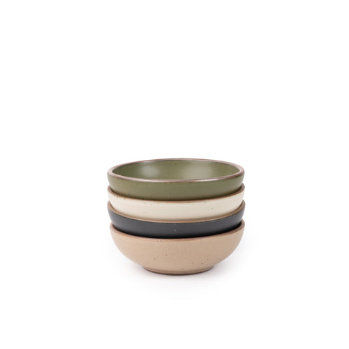 A stack of 4 small shallow ceramic bowls in an olive green, graphite black, off-white, and warm pale brown colors featuring iron speckles and an unglazed rim