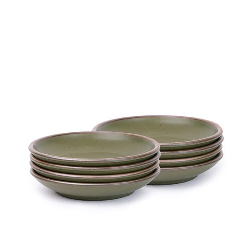 A stack of 8 small ceramic plates with a curved bowl edge in an olive green color featuring iron speckles and an unglazed rim.