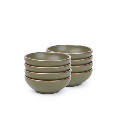 A stack of 8 small shallow ceramic bowls in an olive green color featuring iron speckles and an unglazed rim