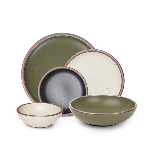 A breakfast bowl, everyday bowl, cake plate, side plate and dinner plate paired together in olive green, graphite black and warm off-white colors featuring iron speckles
