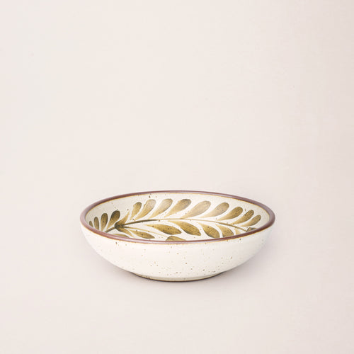 Medium ceramic shallow bowl with a hand-painted olive green leaf border on a cream interior and exterior with an exposed clay rim.