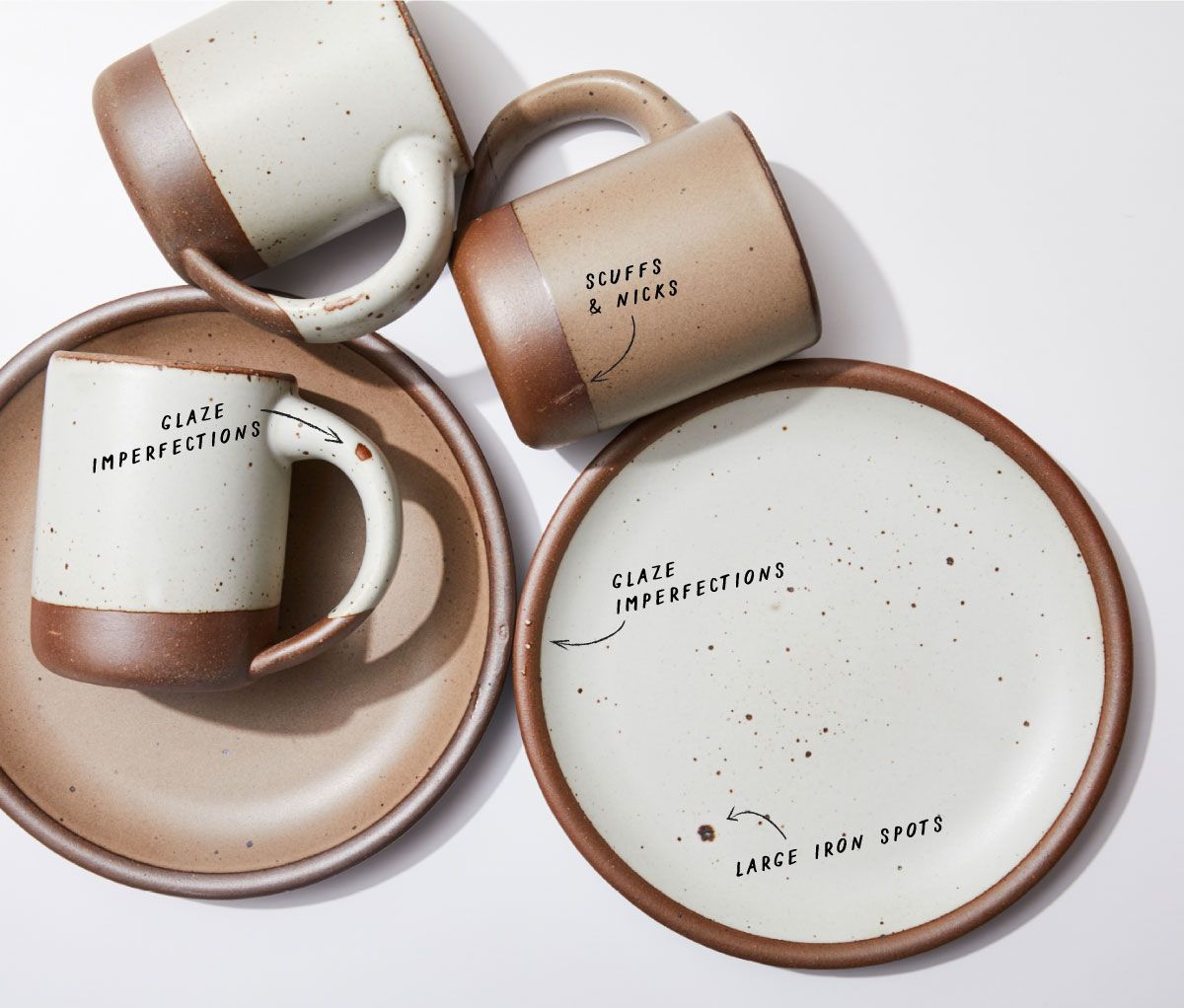 Ceramic plates and mugs with text pointing out seconds features like 'Large Iron Spots' and 'Glaze Imperfections'