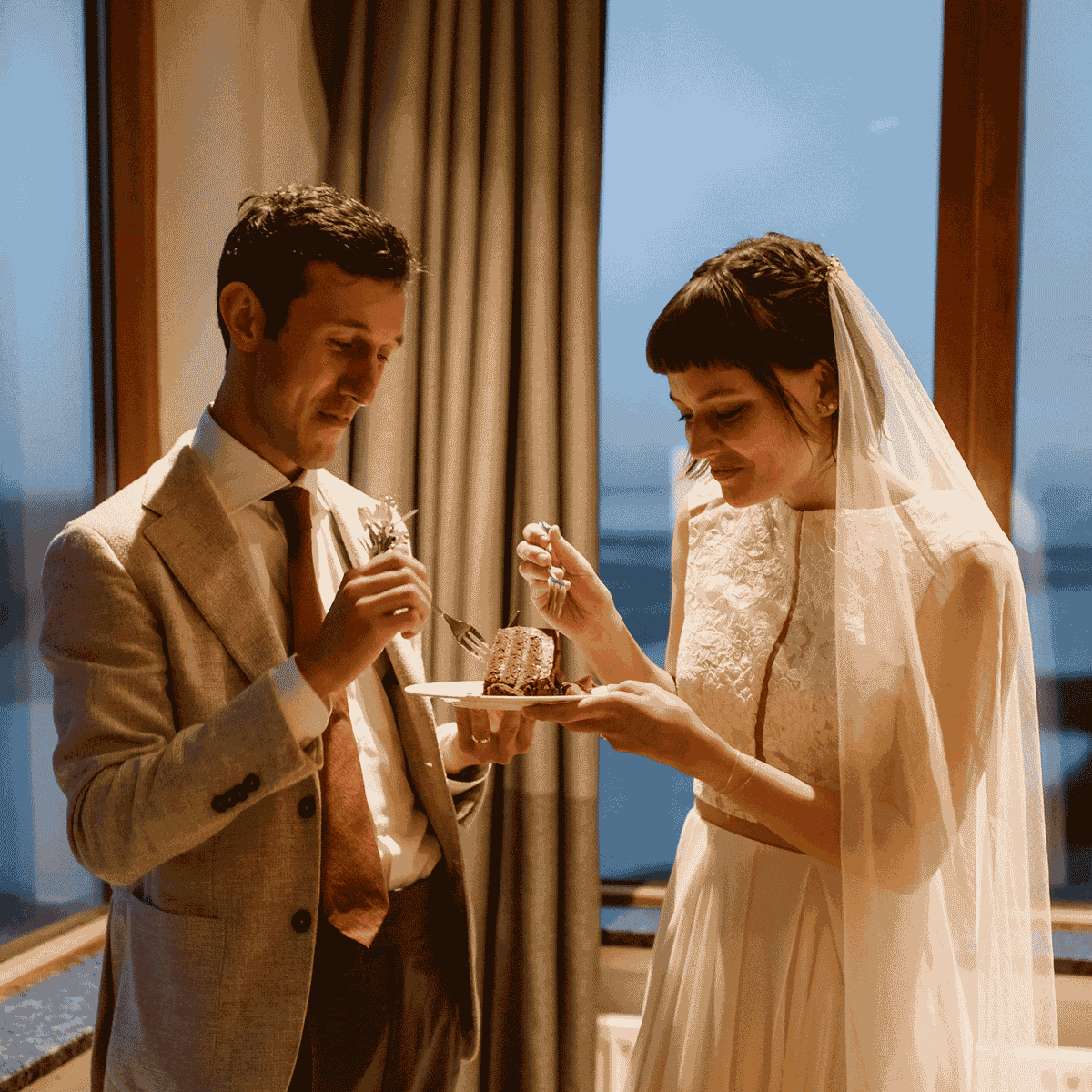 A gif of James and Eva eating cake at their wedding.