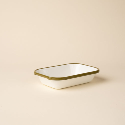 Small rectangular baking dish in a white color with an olive green rim.